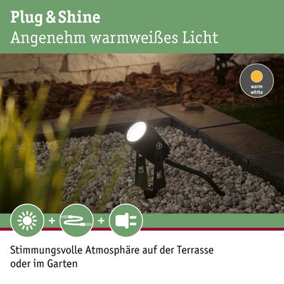 Schwarzer LED-Gartenstrahler mit warmweißem Licht auf Kies für stimmungsvolle Terrassenbeleuchtung