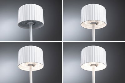 Four views of a white floor lamp with ribbed shade and LED lighting for living spaces