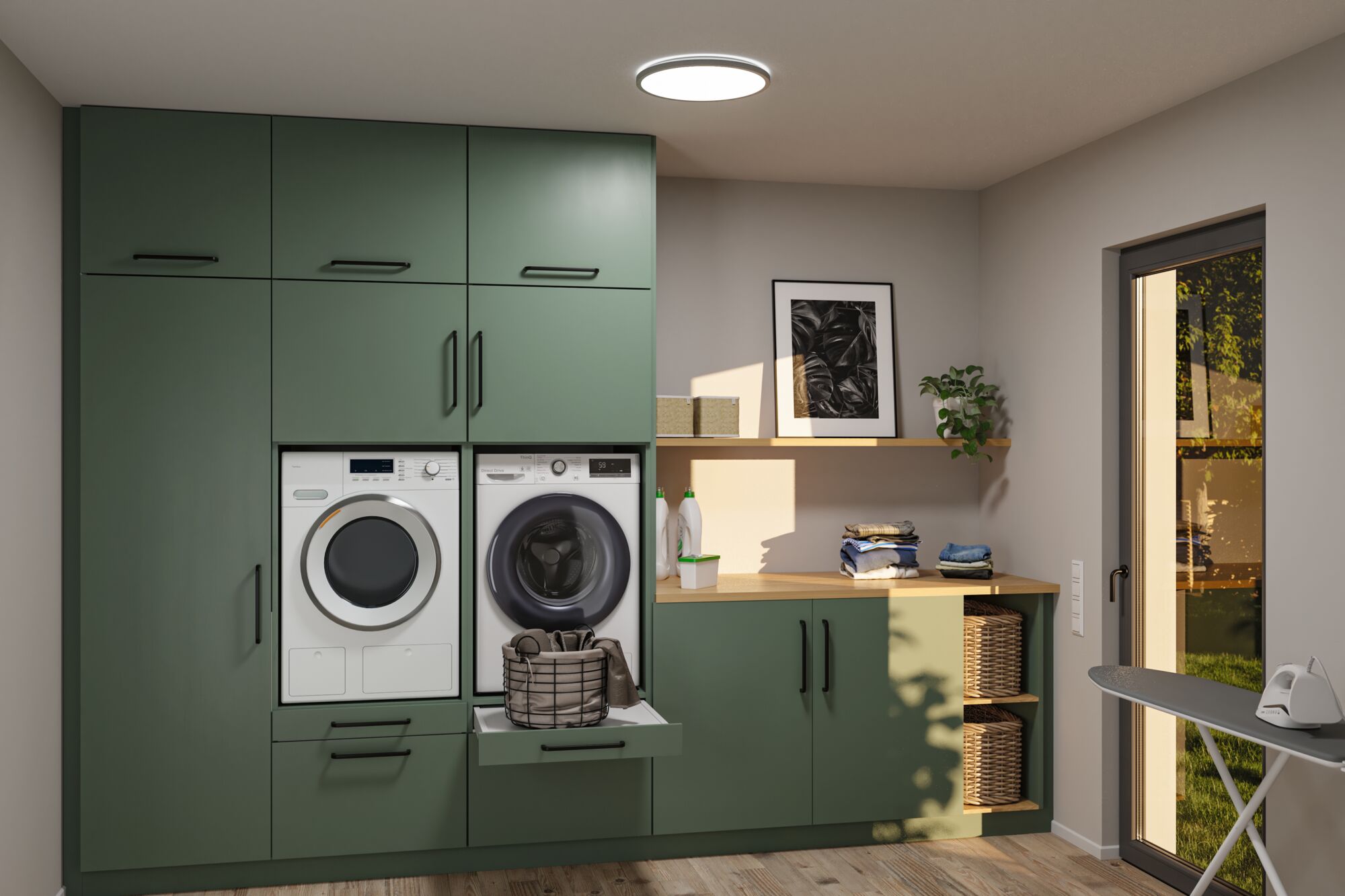 Buanderie moderne intégrée verte avec machine à laver, sèche-linge, plan de travail en bois et panier à linge.