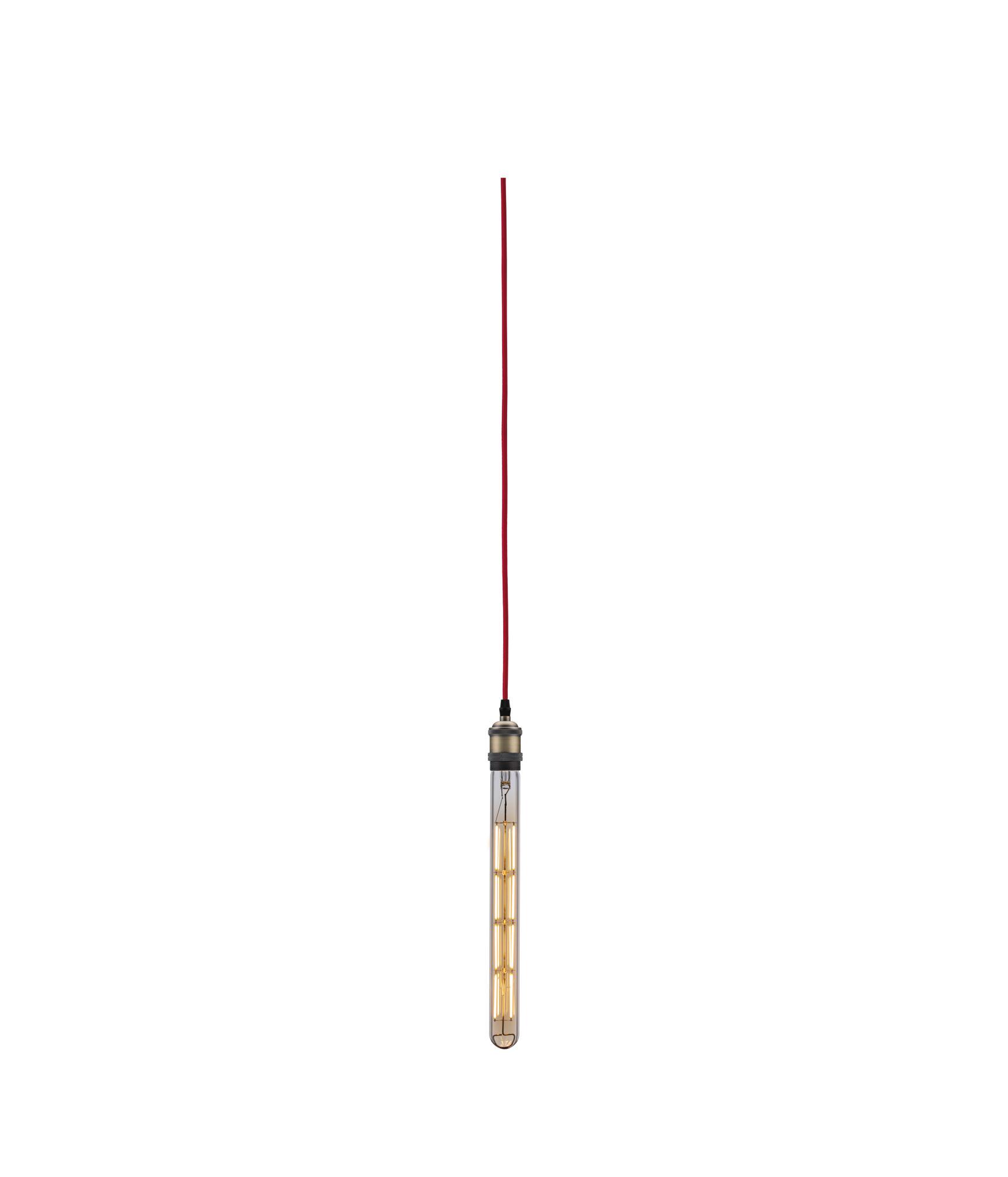 Long vintage light bulb with red fabric cable and metal socket for decorative lighting