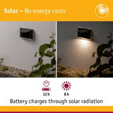 Black solar wall light on white wall with 12h runtime and 8h solar battery charging time