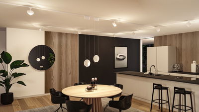 Moderne Küche mit runder Holz-Tischplatte, schwarzen Stühlen und minimalistischer LED-Deckenbeleuchtung