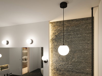 Modern pendant and wall lamps with white glass globes and black metal in stylish bathroom lighting.