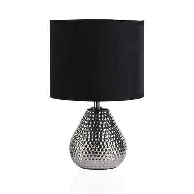Table lamp with black fabric shade and silver dimpled metal base for stylish home lighting