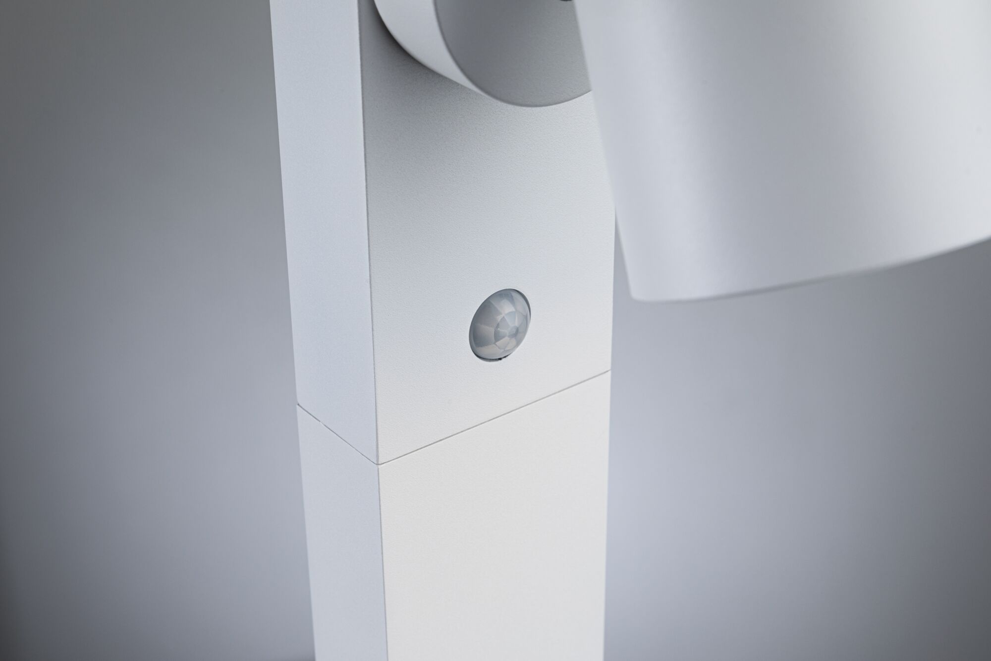 Close-up of white LED spotlight with built-in motion sensor made of plastic for indoor lighting