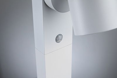 Close-up of white LED spotlight with built-in motion sensor made of plastic for indoor lighting
