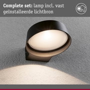 Ronde zwarte buitenwandlamp met vaste lichtbron gemonteerd op grijze muur voor buitenverlichting