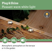 Small LED recessed light with warm white glow on wooden terrace for garden lighting
