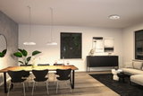 Moderne spisestue med træbord, sorte stole og hvide Paulmann LED-loftslamper til belysning i stuen.