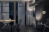 Salon moderne avec lampe sur pied noire, fauteuil gris, chaise géométrique et éclairage LED élégant