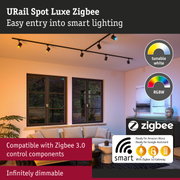 Black URail Spot Luxe Zigbee track lighting with dimmable LED spots in a modern living room.