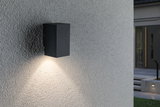 Black aluminum wall light with warm white LED downlight for outdoor use and house facades.
