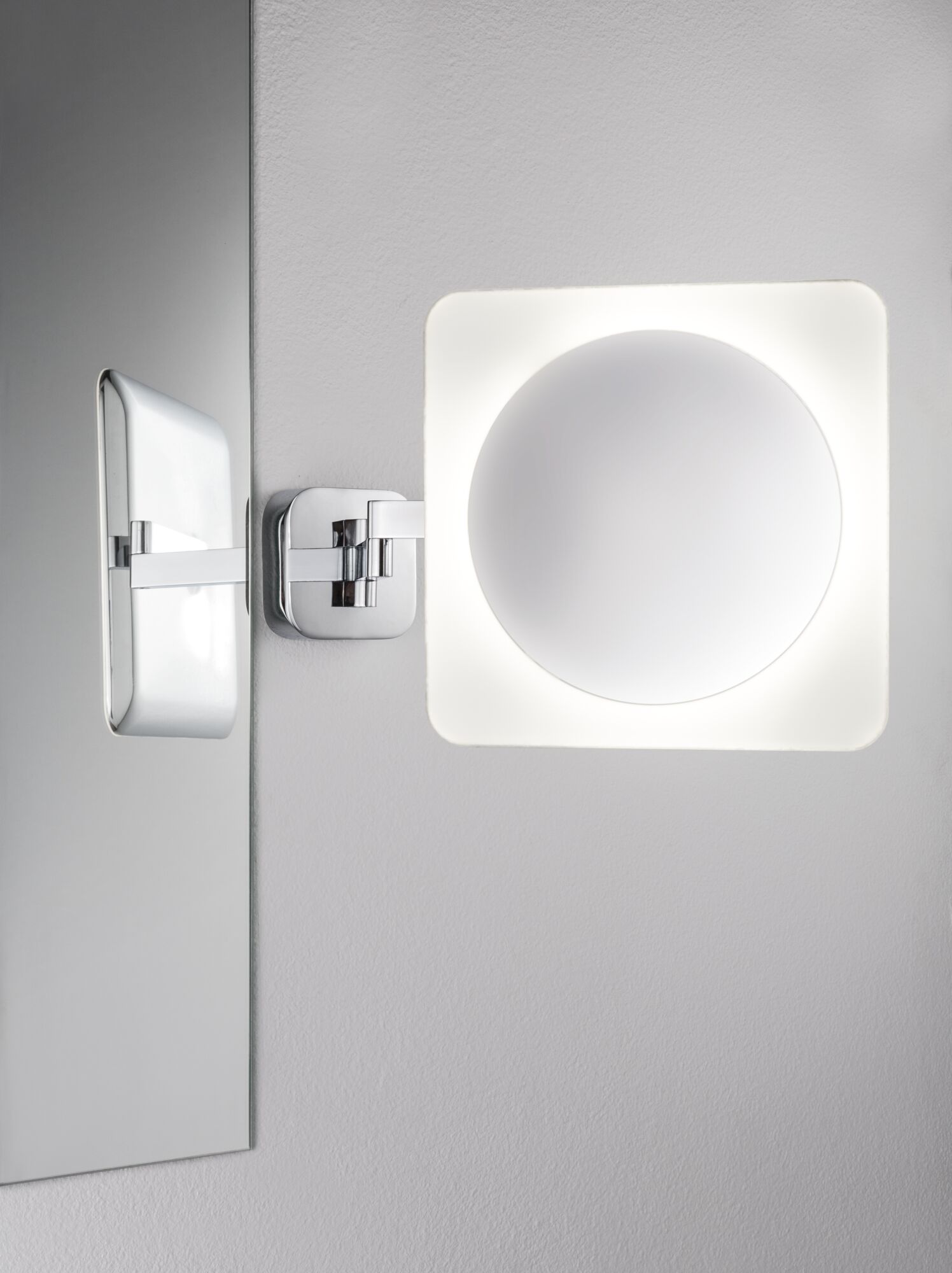 Modern wall mirror with adjustable chrome arm and white LED lighting for bathroom use.