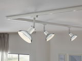 Three white LED ceiling spotlights with chrome accents on white track for modern room lighting