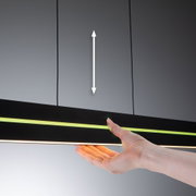 Hand touching black LED light with green and warm white strip for modern lighting design