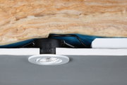 White LED recessed spotlight with black housing in ceiling insulation, energy-efficient lighting solution