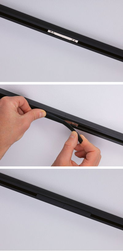 Black plastic rail cover being installed on a track for LED lighting systems and accessories