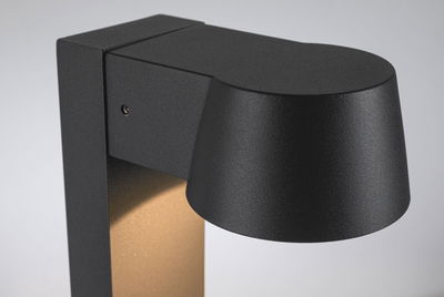 Black metal outdoor wall light with matte finish and warm white LED for garden lighting