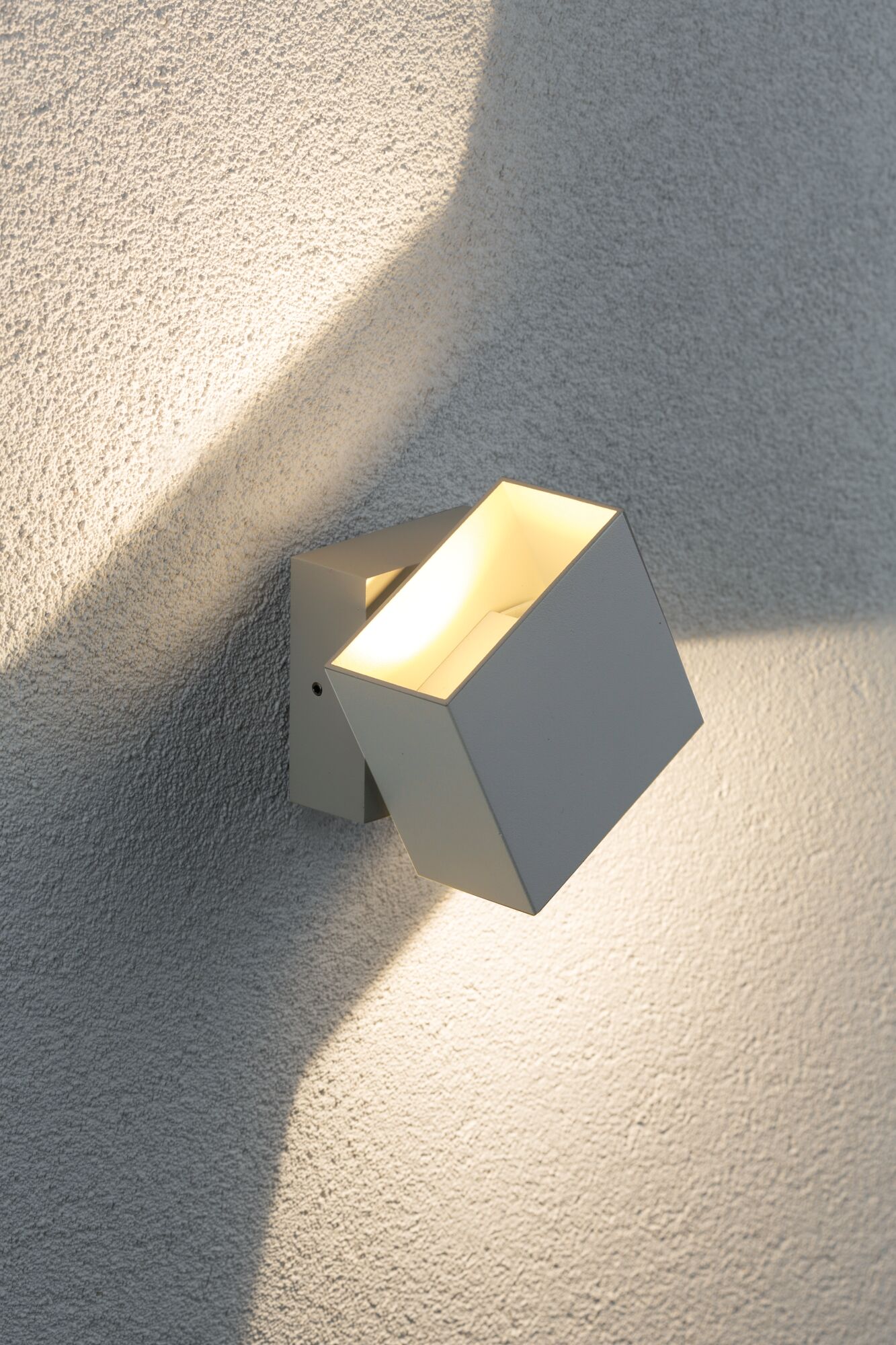 Modern white metal LED wall spotlight with warm white light for outdoor use