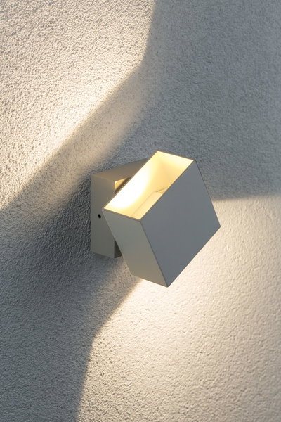 Modern white metal LED wall spotlight with warm white light for outdoor use