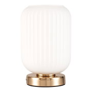 Modern table lamp with white ribbed glass and gold metal base for stylish lighting in interiors