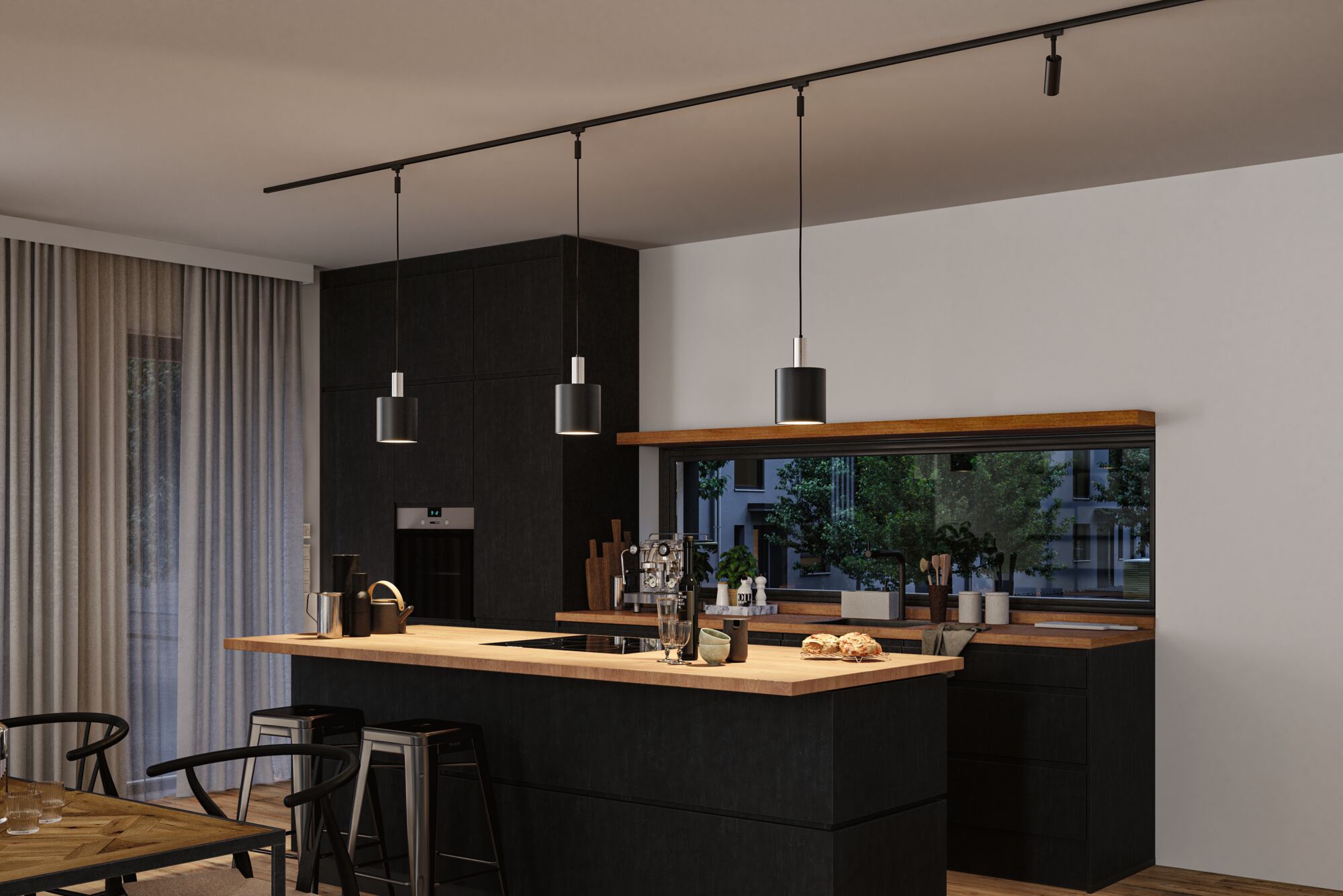 Modern kitchen with black wood island and wooden countertop, three black pendant lights on track system.