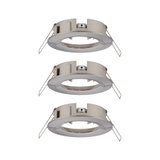 Three round brushed stainless steel recessed frames in silver for LED spotlights.