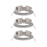 Three round brushed stainless steel recessed frames in silver for LED spotlights.