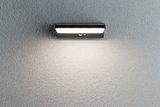 Applique murale LED noire en métal avec détecteur de mouvement sur mur gris pour éclairage extérieur