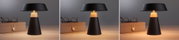 Schwarze Tischlampe aus Metall mit warmweißem Licht neben brauner Brillenbox auf Holztisch