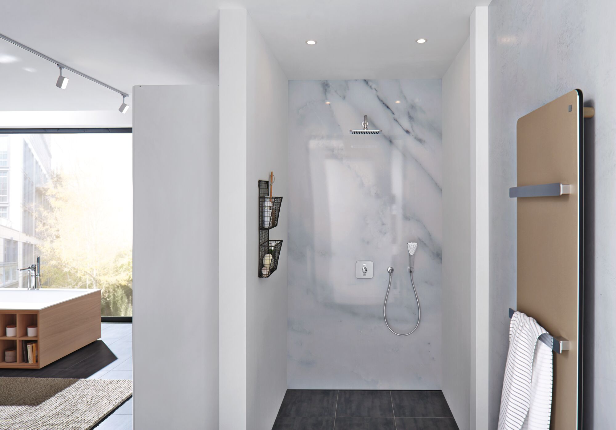 Modern shower with marble wall, chrome showerhead and handheld shower in stylish bathroom.