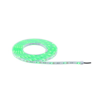 Green glowing LED strip light on roll with transparent material for flexible room lighting.