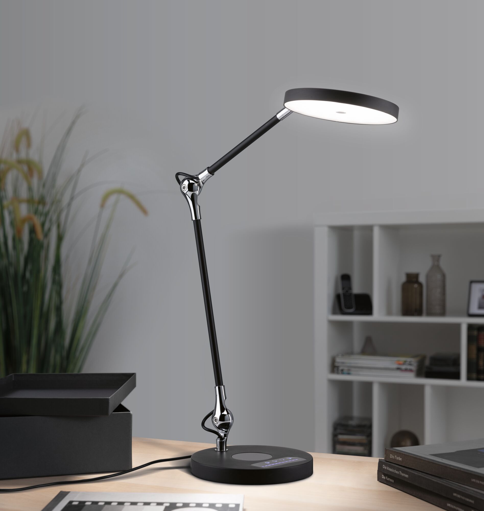 Modern black LED desk lamp with round light head and touch control panel for office lighting