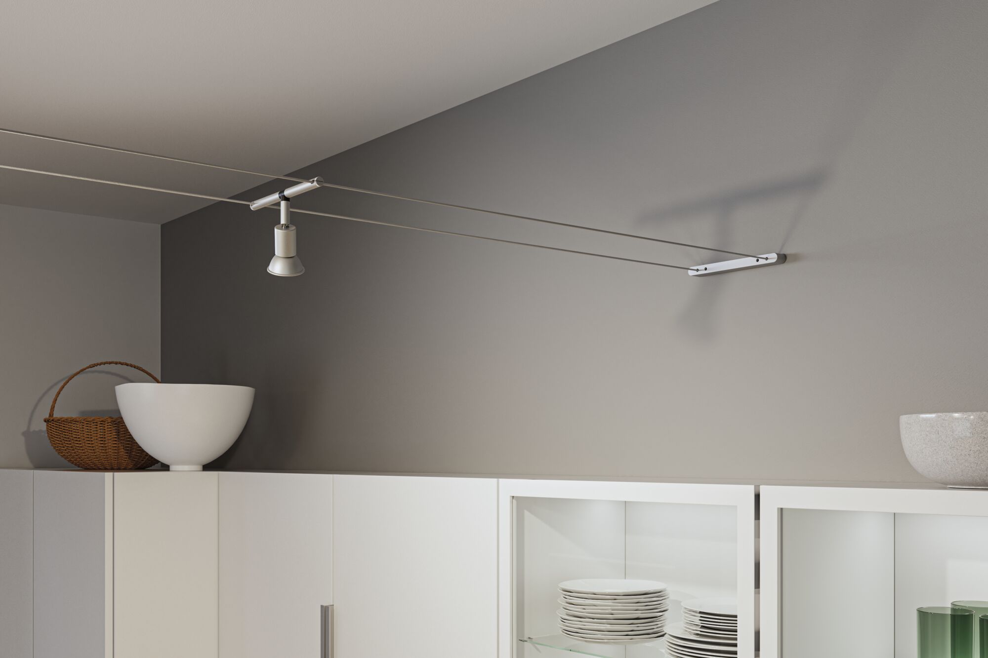 Moderner Seilstrahler in Weiß mit Aluminiumhalterung an grauer Wand für flexible Beleuchtung