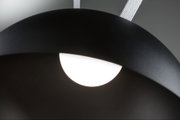 Black metal pendant lamp with white LED light and textile suspension for modern lighting design.