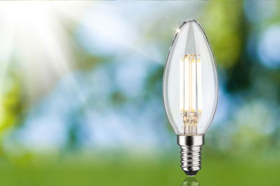 Clear LED candle bulb with E14 base, energy-efficient lighting for home use.