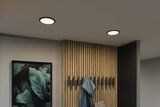 Moderne runde LED-Deckenleuchten mit schwarzem Rahmen in minimalistischem Flur mit Holzpaneelen.