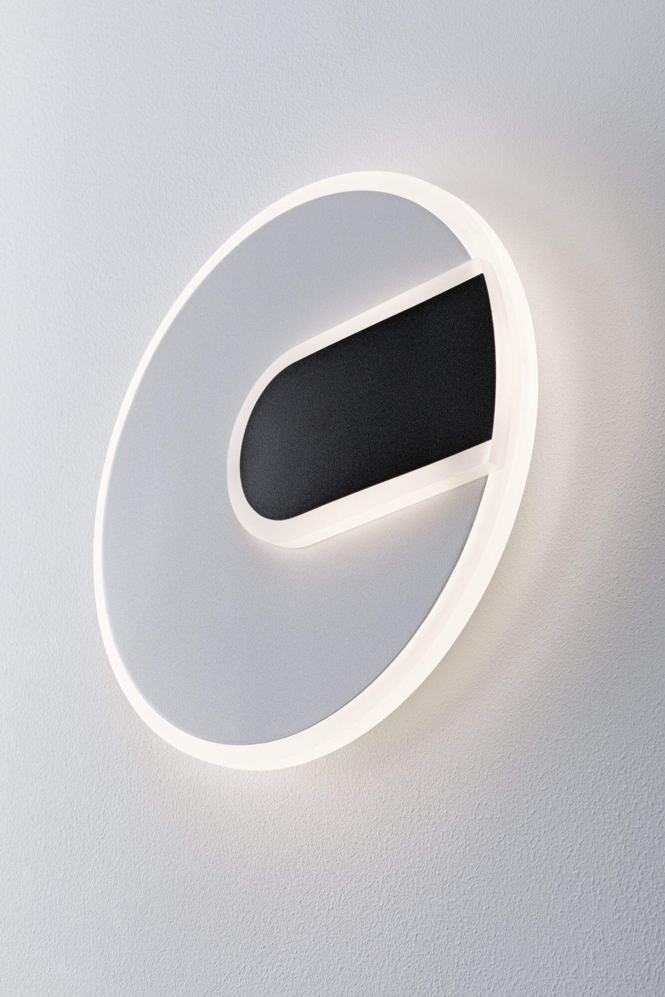 Round LED wall light in white and black with modern design for stylish room lighting