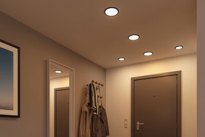Flade runde LED-loftslamper i varmt hvidt lys oplyser moderne entré med knagerække og spejl.