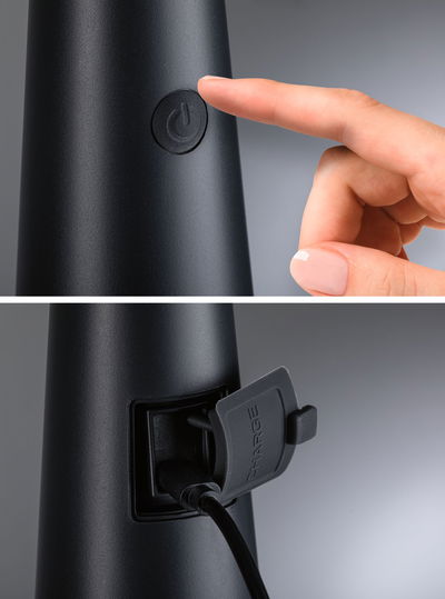 Black electronic device with power button and charging port covered by a protective flap in plastic