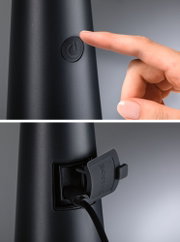 Black electronic device with power button and charging port covered by a protective flap in plastic