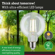 Clear LED bulb with warm white light and ultra-efficient energy use against green forest background