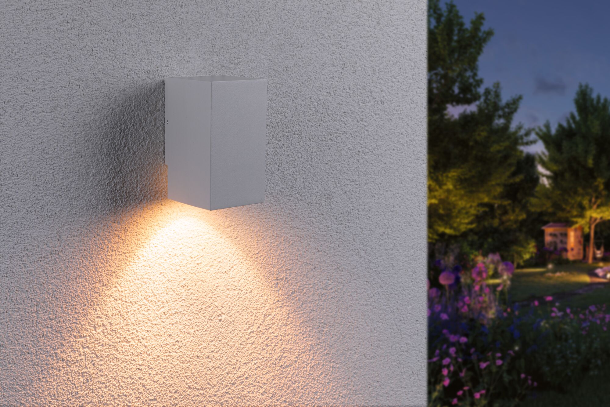 Modern white aluminum wall light with warm white illumination for outdoor and garden lighting.