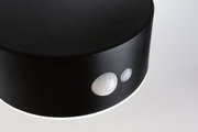 Round black solar light with motion sensor and LED ring for outdoor use
