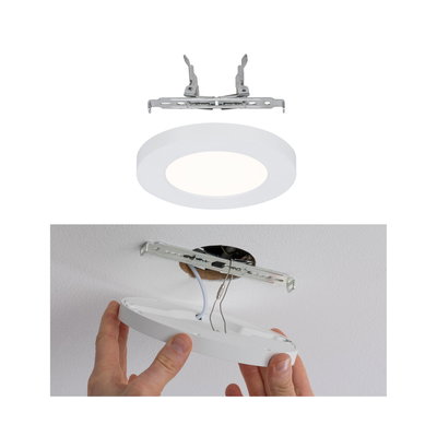 Round white LED recessed panel with metal bracket, ceiling installation with cable connection.
