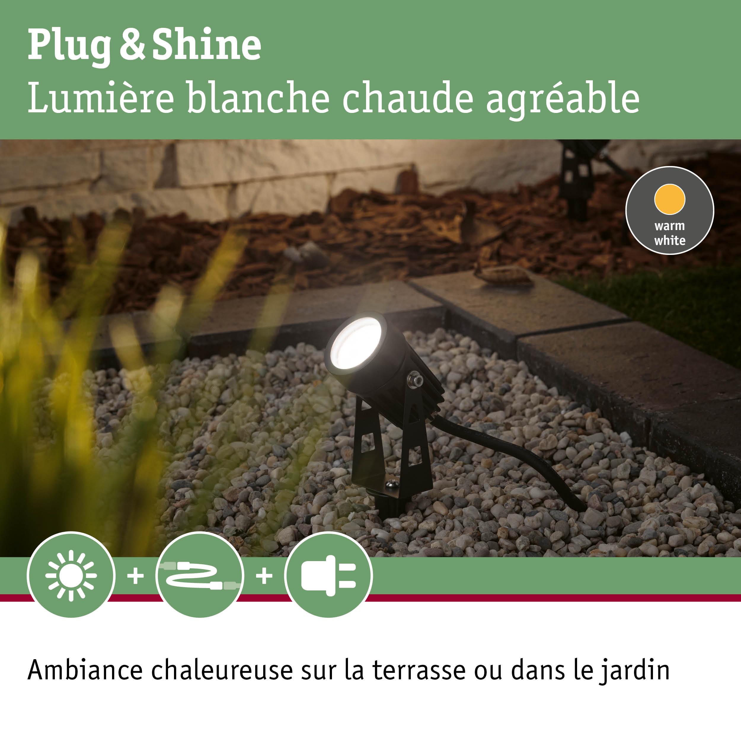 Projecteur extérieur noir avec lumière blanche chaude sur gravier pour terrasse et jardin