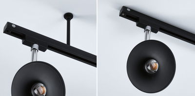 Black ceiling light with round reflector and chrome rod, modern LED spotlight for indoor use.