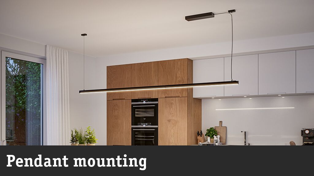 Black LED pendant light above modern kitchen with wood and white cabinets, minimalist interior lighting