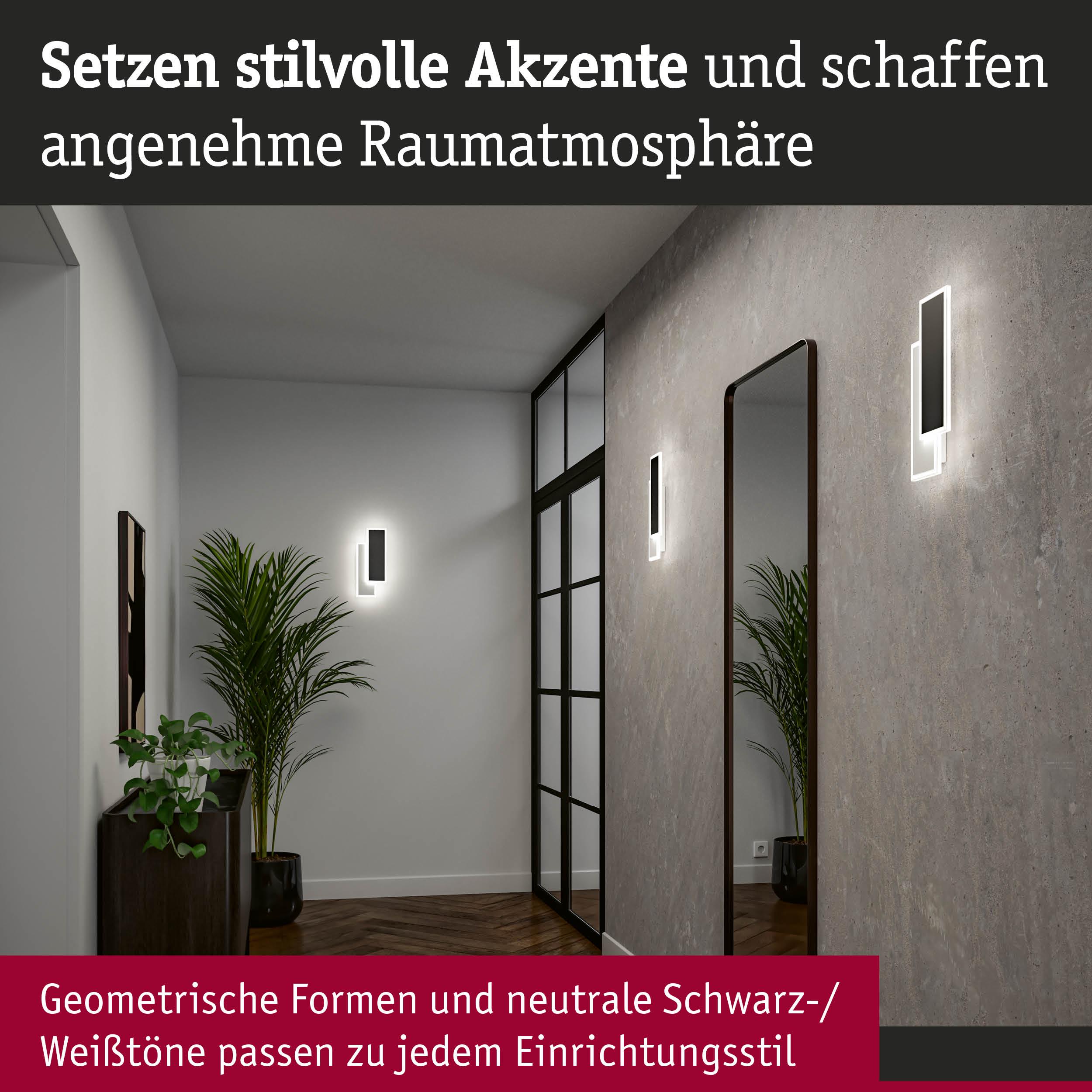Moderne schwarze LED-Wandleuchten mit geometrischem Design an grauer Wand im Flur mit Spiegel und Pflanzen