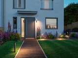 Modern outdoor lighting with black LED path lights and wall lamp at grey front door with garden path
